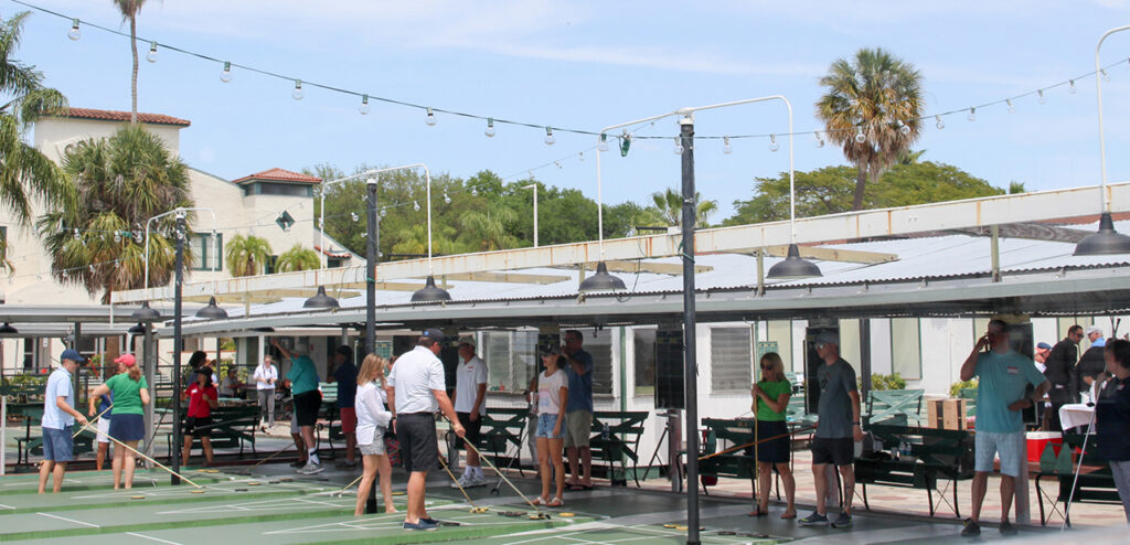 An image of a large group of people playing Shuffleboard