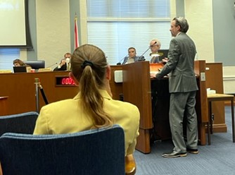 An image of President Logan DeVicente of Waterfront Parks Foundation giving a speech to the City Council regarding the Foundation.